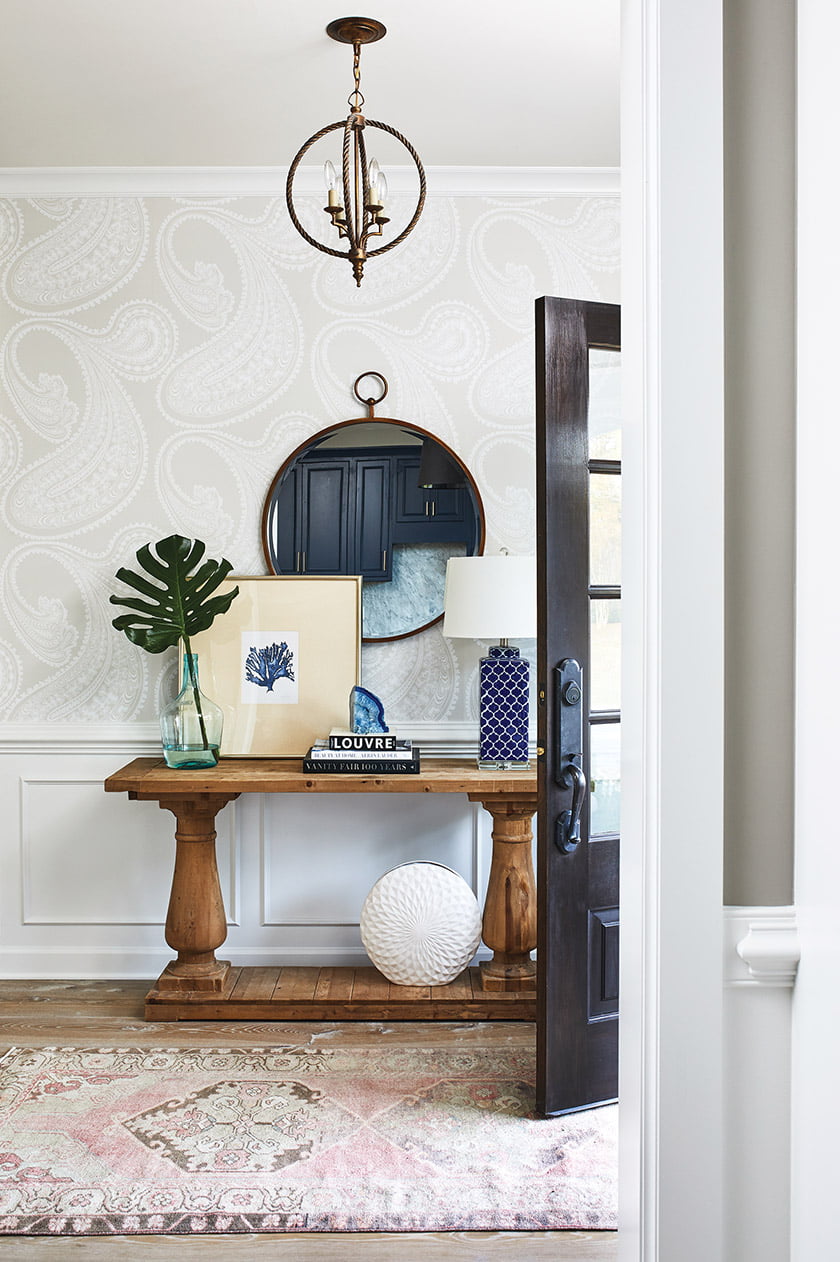 The entryway features Cole and Son’s Rajapur wallpaper.