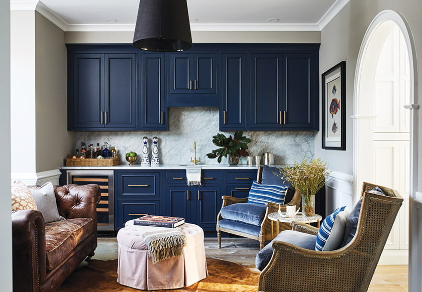 The entryway opens into a new wine room featuring striking navy-blue cabinetry.