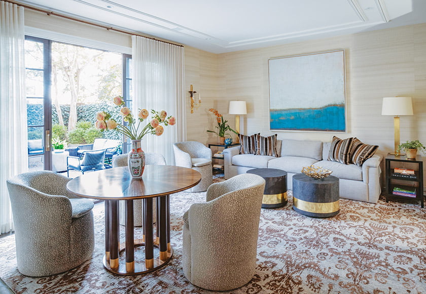 Brass accents on the table by Keith Fritz and the Made Goods drum tables lend the family room a touch of glam.