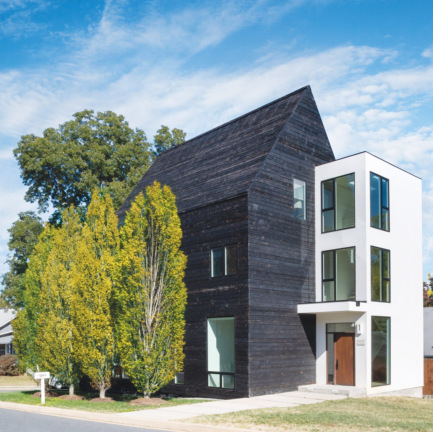 Block-like volume covered in HardiePanel siding houses the stairs.