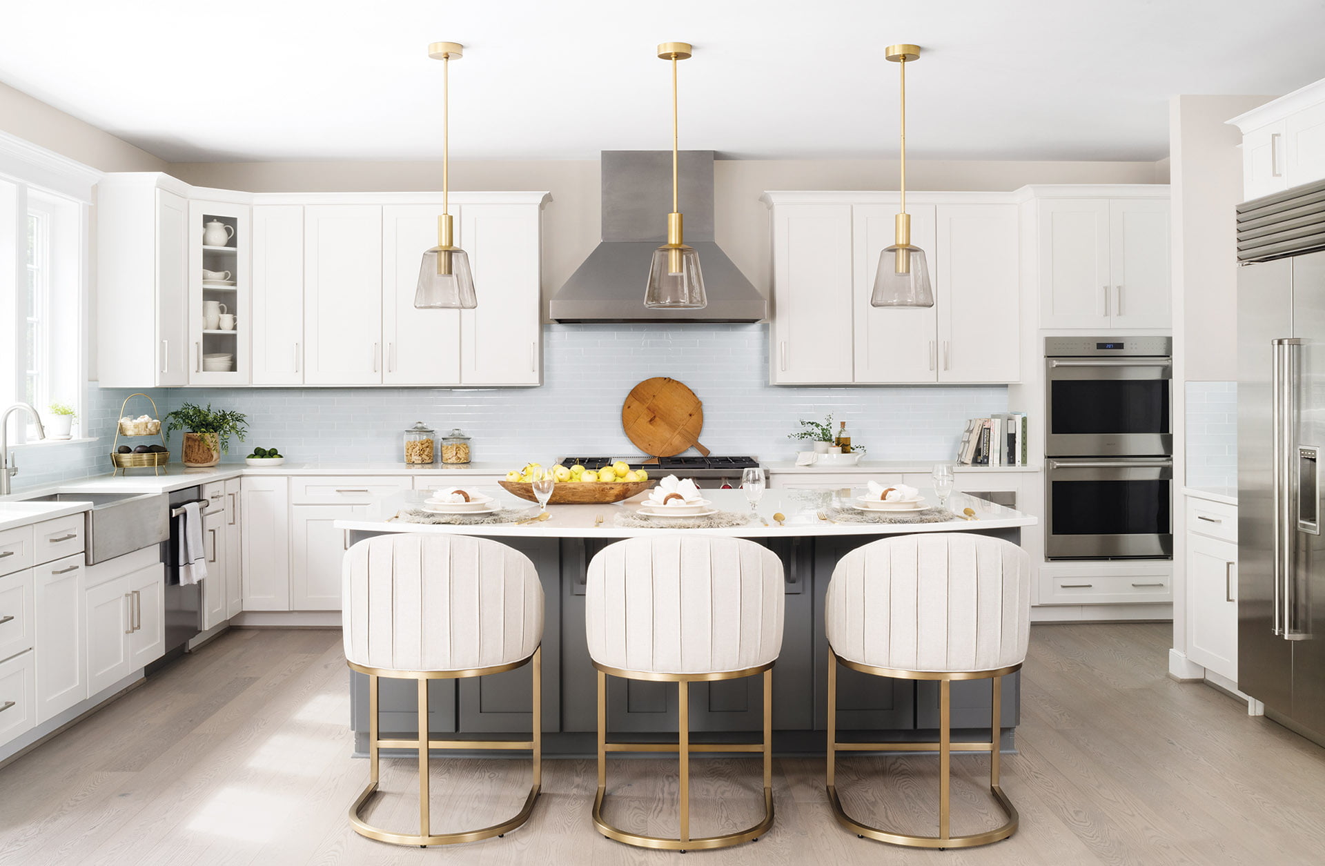 Kitchen with chic Vanguard stools and Arteriors pendants.