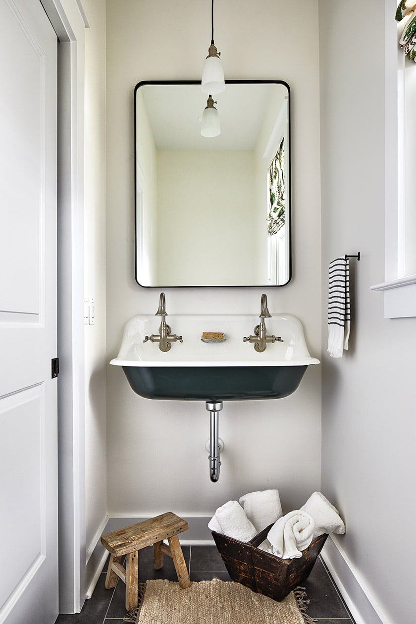Powder room features a farmhouse-style sink.